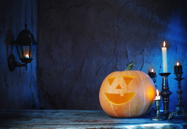 istock Halloween pumpkins on wooden table on dark background 846783412