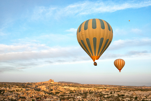 Hot air balloon and Uchisar Town at the bakground, Cappadocia, Nevsehir, Turkey