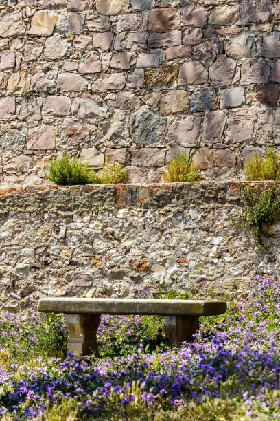 Bench between the flowers and front wall in Montjuic, Barcelona, Spain.