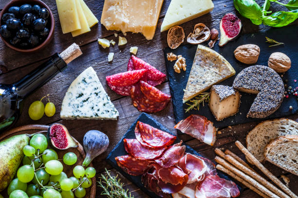 delizioso antipasto su tavolo rustico in legno - wine cheese food salami foto e immagini stock