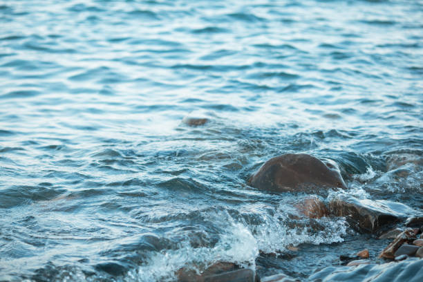 istock Stone beach at sunset. Sea waves on the coast. 846798176