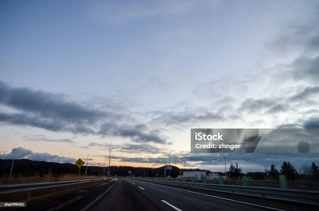 Road trip from Asahikawa to Sapporo, Hokkaido. Beautiful sunset view along the road from Asahikawa to Sapporo, Hokkaido's largest city. Driving in Hokkaido is amazing, the road-trip was full with amazing view of natural scene. Arrival Stock Photo