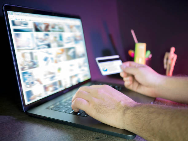 istock Online payment, Close up business man hands holding a credit card and using laptop computer for online shopping 846801076