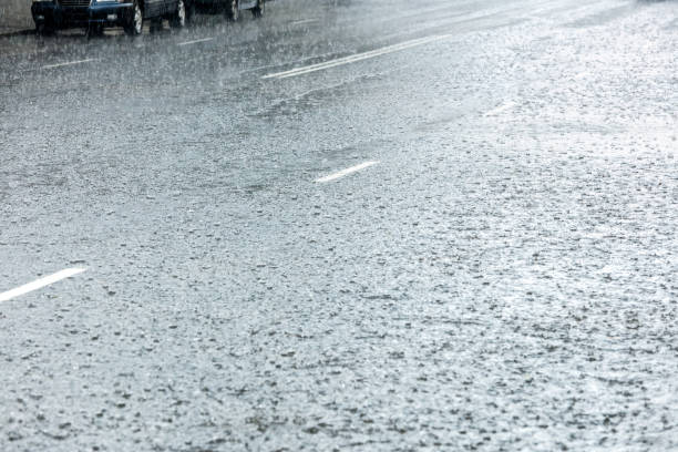 istock flooded road with streaming water and raindrops splashes 846805822
