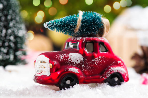 istock Miniature red car carrying fir tree on Christmas background 846806062