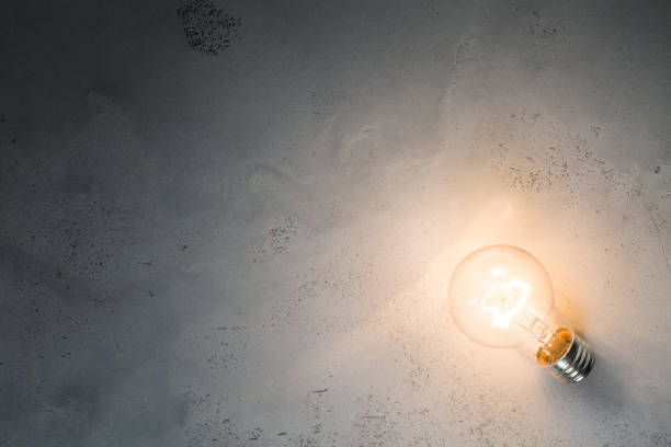 istock Vintage incandescent bulb on concrete background 846811406
