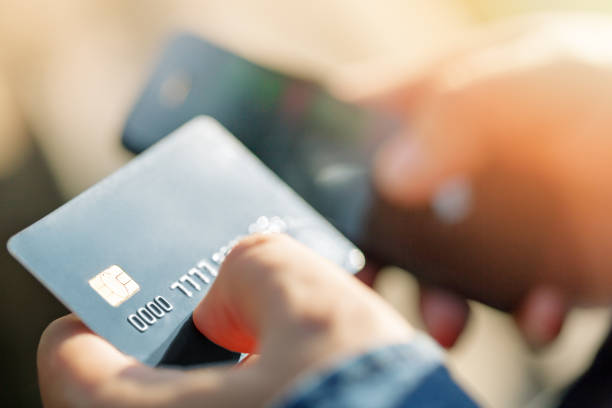istock A man uses a mobile phone to pay for utilities. 846814618