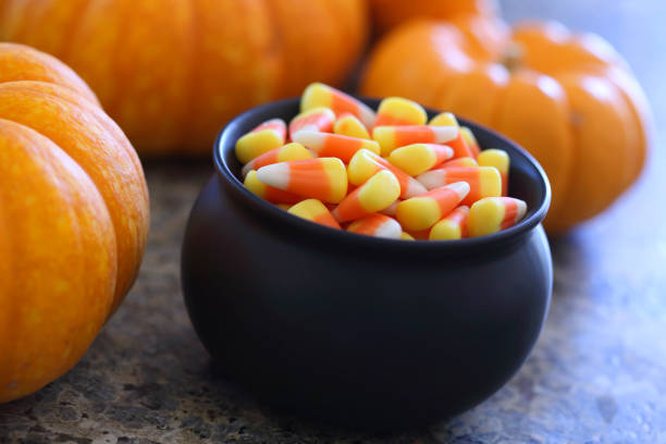 istock Pot Of Candy Corn Next To Pumpkins 846814714