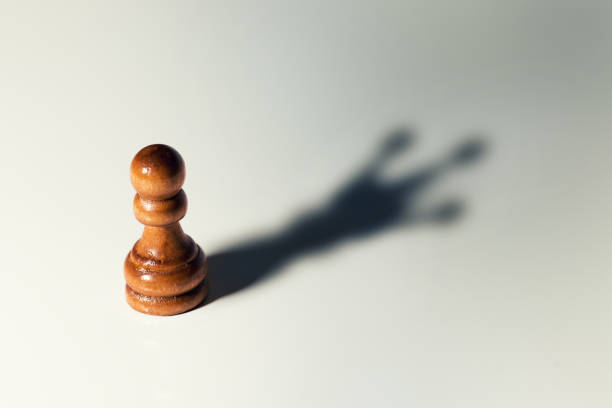 trust yourself concept - chess pawn with king shadow trust yourself concept - chess pawn with king shadow pawn chess piece photos stock pictures, royalty-free photos & images