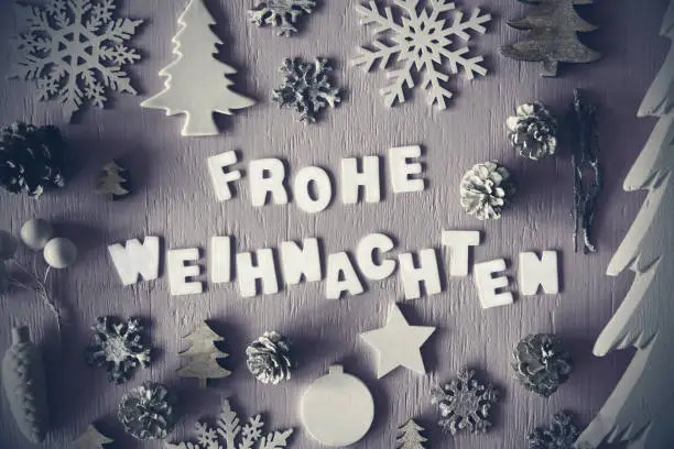Letters Building German Word Frohe Weihnachten Means Merry Christmas. Many Christmas Decoration Like Tree, Fir Cone And Snowflake. Flat Lay With Black And White Wooden Background And Vintage Style