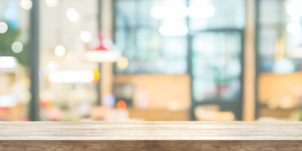 istock Empty wooden table top with blur coffee shop or restaurant interior background, Panoramic banner. Abstract background can be used product display. 846819670