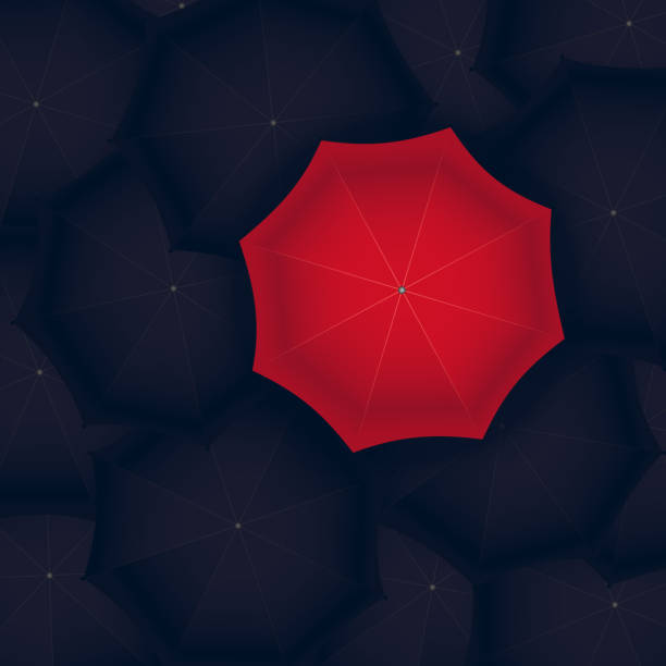 istock concept of red umbrella standing out of the black 846823980