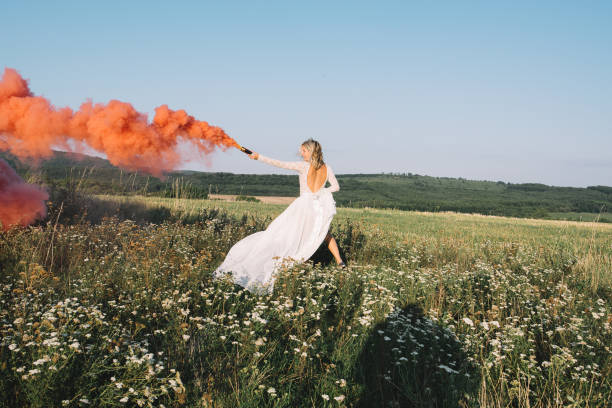 istock Happy bride running with red smoke 846830364