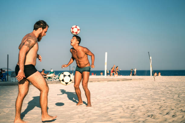 istock Men bouncing soccer ball on beach, Rio de Janeiro, Brazil 846830822