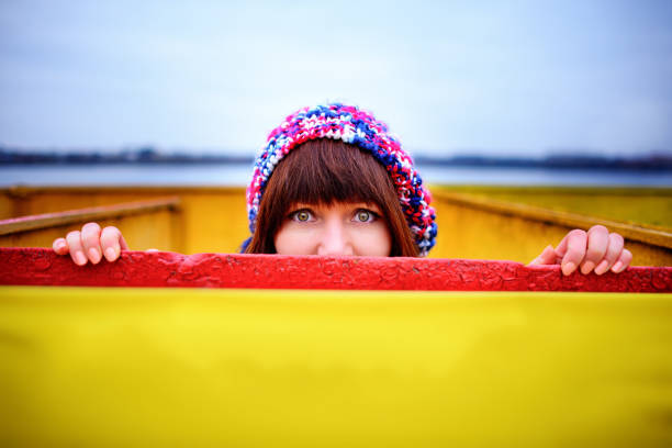 A young woman holding a yellow board