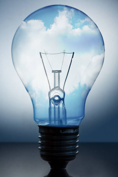 istock Close up of big light bulb standing with bright blue sky in it 846837350