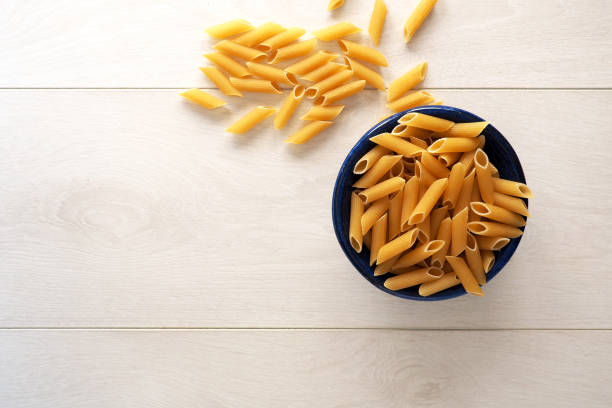 Pasta in a bowl on wooden background