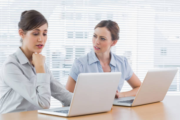 istock Worried businesswomen working on laptops 846838620