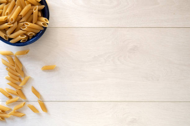 Pasta in a bowl on wooden background