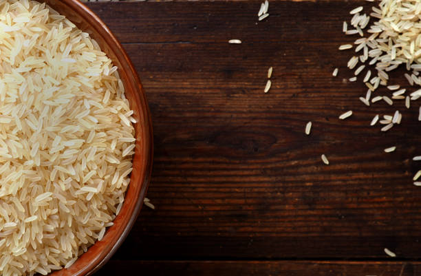 istock Rice in a bowl on textured wood 846841210