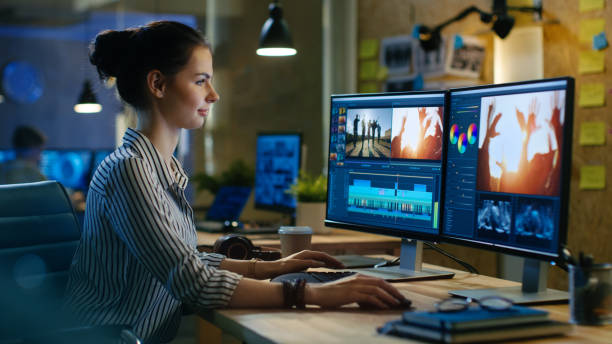 Beautiful Female Video Editor Works with Footage on Her Personal Computer, She Works in Creative Office Studio. Beautiful Female Video Editor Works with Footage on Her Personal Computer, She Works in Creative Office Studio. multimedia studio stock pictures, royalty-free photos & images