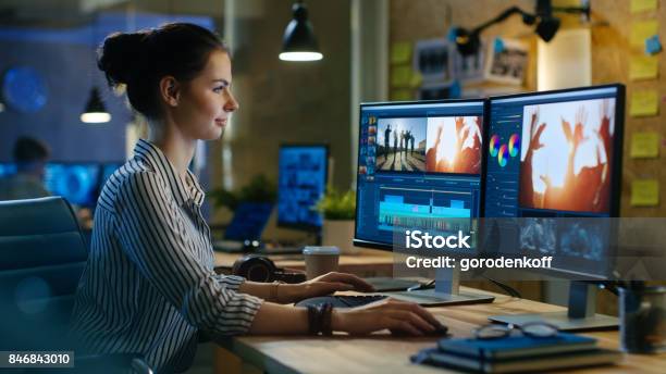 Beautiful Female Video Editor Works With Footage On Her Personal Computer She Works In Creative Office Studio Stock Photo - Download Image Now