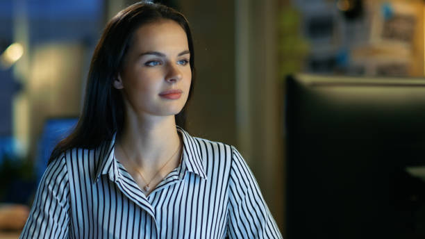 istock Beautiful Young Woman Works on Personal Computer. She Works in a Modern Office Loft Studio Space. 846845574