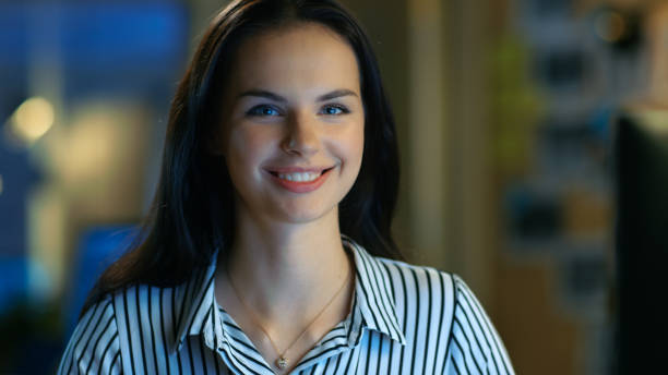 istock Beautiful Young Woman Works on Personal Computer, She Charmingly Smiles into Camera. She Works in a Modern Office Loft Studio Space. 846845582