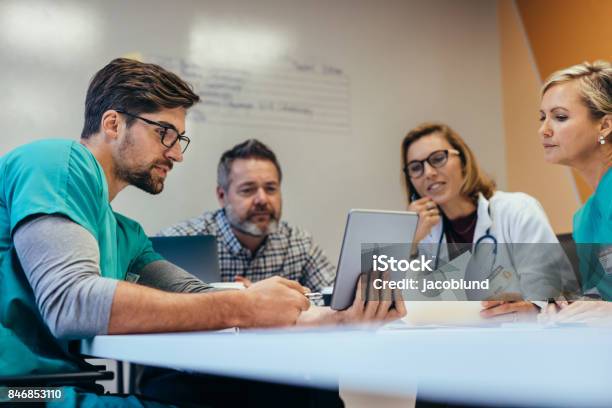 Medical Staff Having Morning Meeting In Boardroom Stock Photo - Download Image Now - Healthcare And Medicine, Meeting, Teamwork