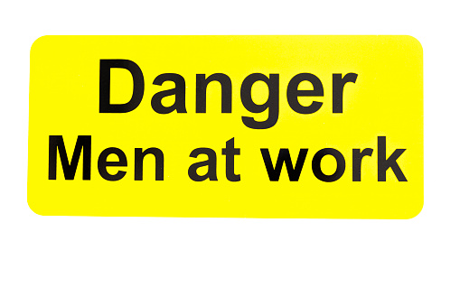 A plank showing sign of Danger, Men at Work