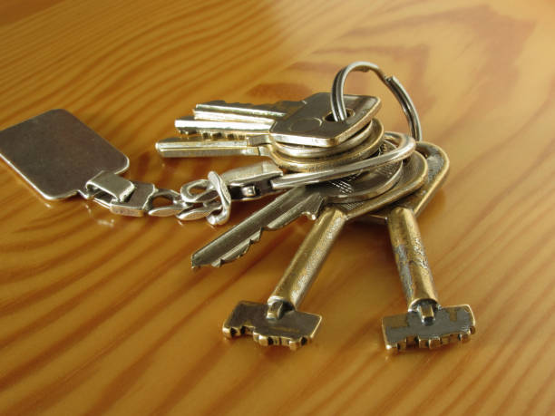 istock Bunch of worn house keys on wooden table 846860072