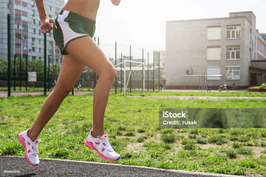 running at outdoor A young beauty athletic woman in sportswear running at outdoor. 20-29 Years Stock Photo