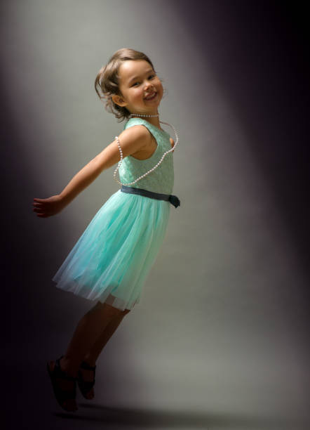 istock Little cute girl dancing  on black background 846863570