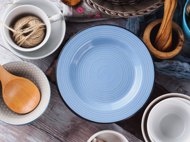 istock Ceramic and enamel crockery on wooden background 846863654