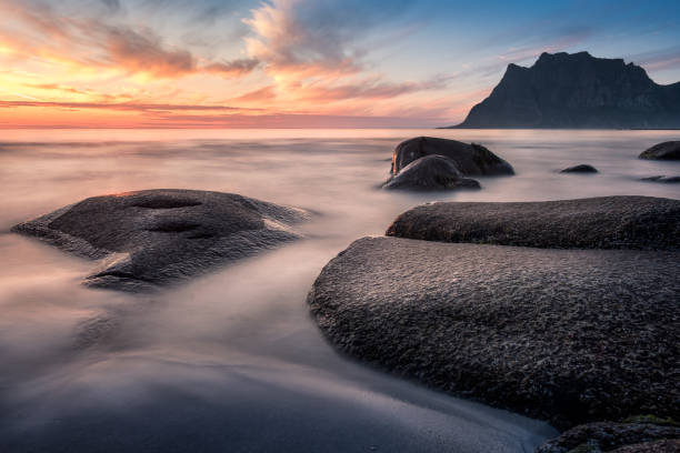 istock Scenic sunset with smooth water at summer night in Lofoten, Norway 846871492