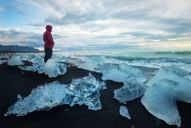 istock Man standing on crystal beach iceland 846883088