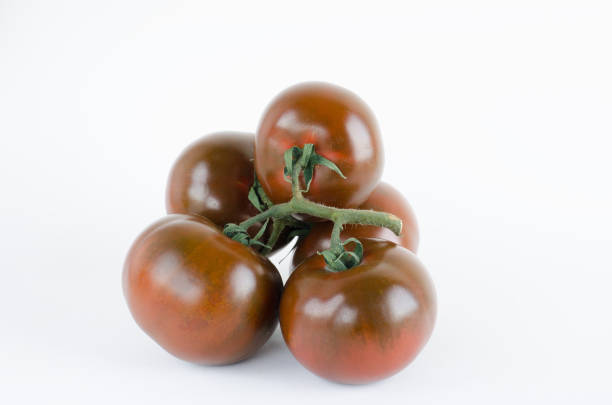 Tomato kumato on white background.