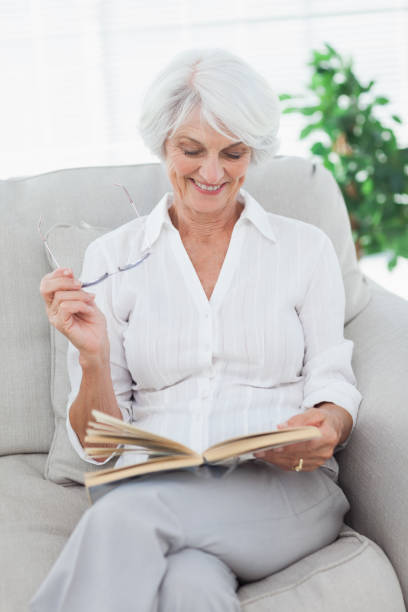 istock Woman reading a book on the couch 846887874