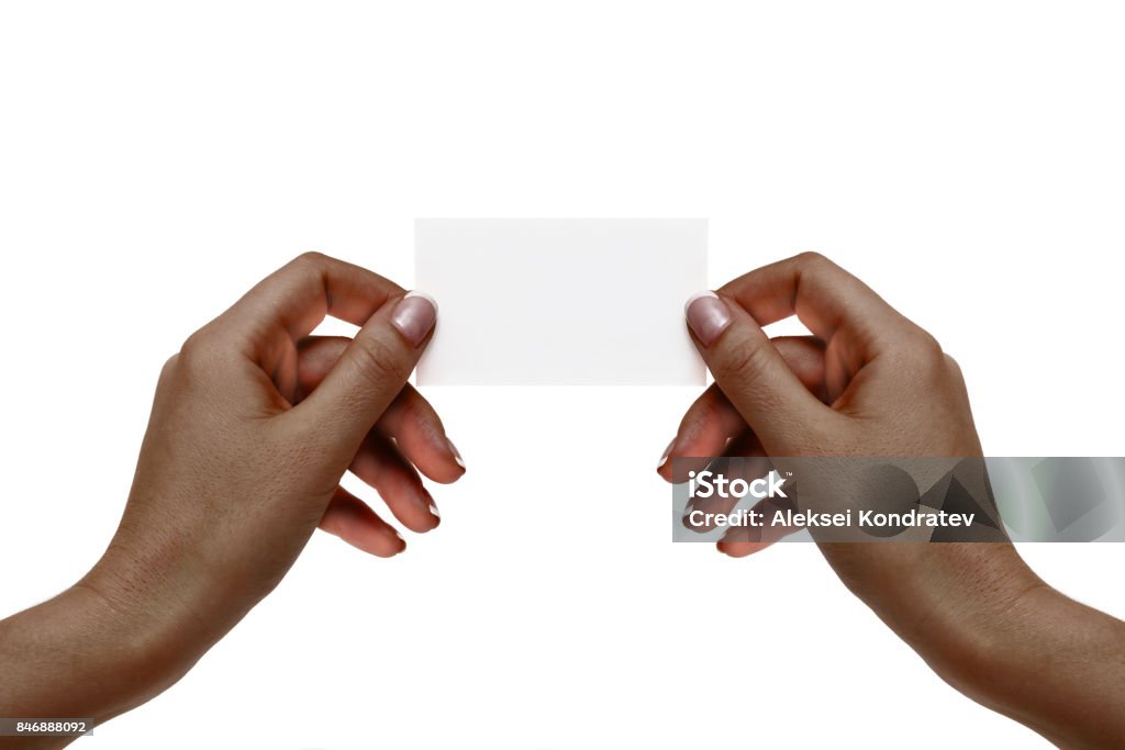 Isolated african female hands hold white card on a white background. African female hands hold white card on a white background. Human Hand Stock Photo