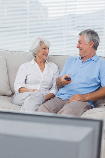 istock Couple watching tv on the couch 846888416