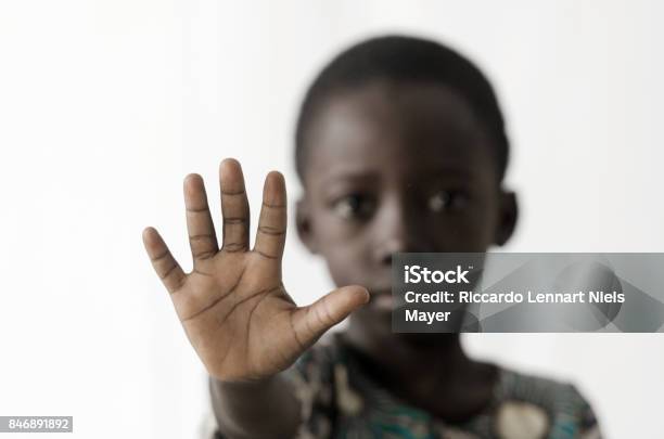 African Boy Makes A Stop Sign With His Hand Isolated On White Stock Photo - Download Image Now