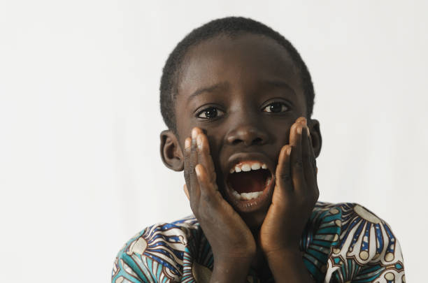 istock Littel African boy surprised holding his mouth open with his hands on, isolated on white 846892070