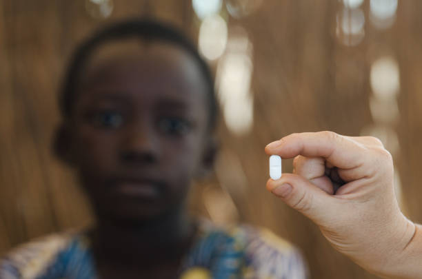 istock Young African boy getting a medicine pill by a white doctor 846892342