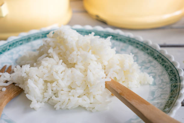 istock close up rice in wooden spoon and fork, selective focus 846895796