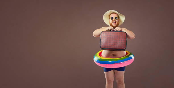 istock Funny fat bearded man with a suitcase in a hat and glasses on va 846902190