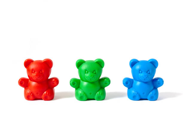 istock Small red, green and blue plastic toy bears isolated on white background 846922754