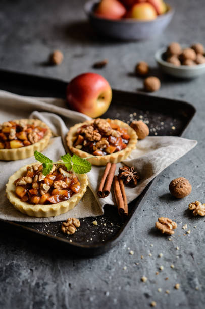 istock Fruit tartlets filled with caramelized apple pieces, cinnamon and walnuts 846936058