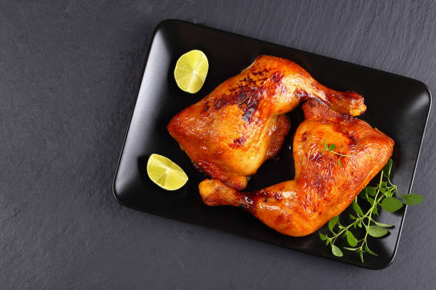 istock roasted chicken legs on black plate 846939488