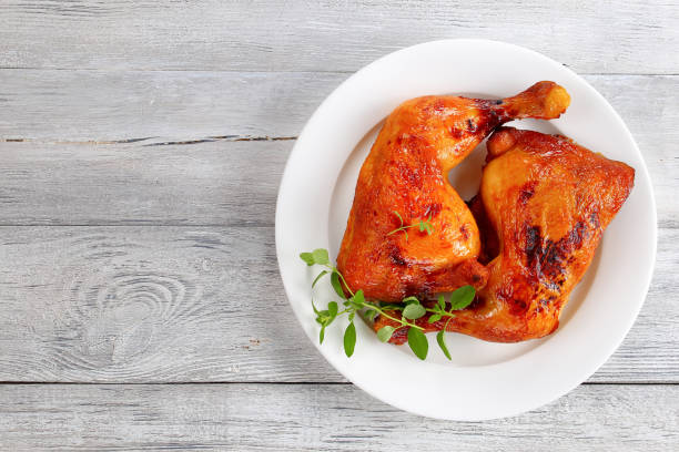 istock roasted chicken leg quarters on plate 846940598