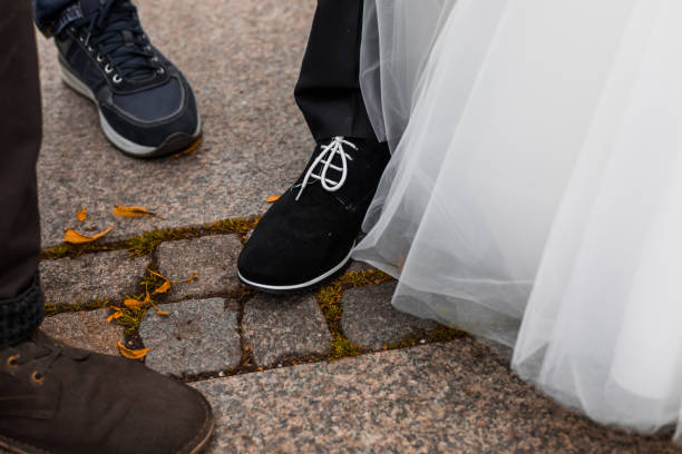 istock Wedding guests and bride with groom looking at each other's shoes 846948890